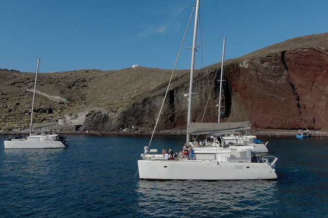 ALL-INCLUSIVE: Santorini Caldera Cruise with Greek Meal & Drinks - Stop 1 and Stop 2: Red Beach and Mesa Pigadia swim breaks off the shore