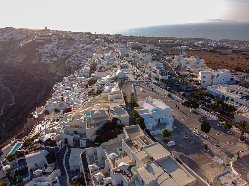 From Fira: Santorini Highlights Minibus Tour with Oia Sunset - Lighthouse and Red Beach: the dramatic contrast that makes Santorini look unreal