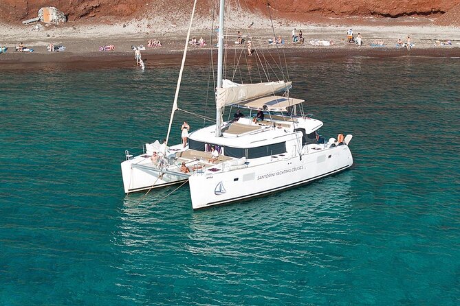 Luxury Santorini Catamaran Cruise: Lunch, BBQ, Drinks, Transfers - Sailing the caldera highlights: Red Beach, White Beach, Indian Rocks, Akrotiri Lighthouse