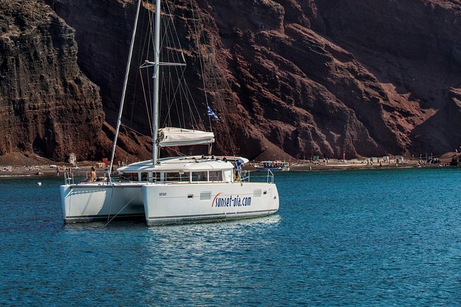 Private Morning Tour Lagoon 400-380 Sailing in Santorini ,lunch, drink, transfer - Views around Aspronissi, the lighthouse, Indian Rock, and Black Mountain
