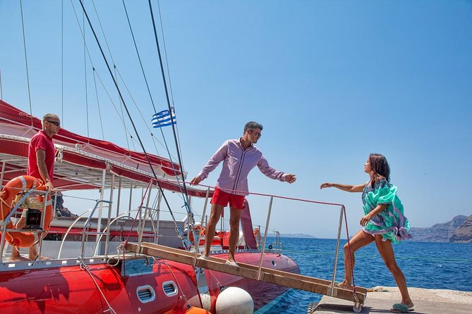 Sailing Catamaran Cruise in Santorini with BBQ, Drinks and Transfer - Snorkeling gear and floating devices: fun, but bring the right expectations