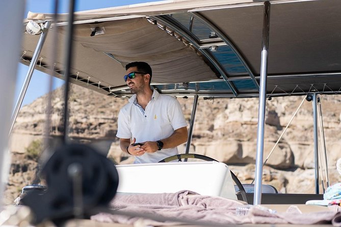 Santorini All-inclusive Catamaran Cruise with Thirassia Stop - White Beach, lighthouse, and Red Beach photo windows