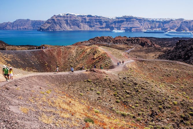 Santorini Caldera Morning Cruise With King Thiras Boat - Cruising across Oia and returning to Athinios: the photo angle from below