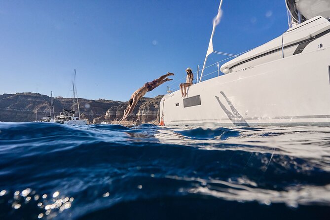 Santorini: Caldera Private Catamaran Cruise with Meal & Drinks - The south coast views: lighthouse moments and caldera context