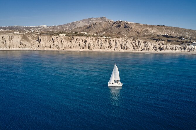 Santorini: Caldera Private Catamaran Cruise with Meal & Drinks - Red Beach and White Beach passing: volcanic colors and quick water time
