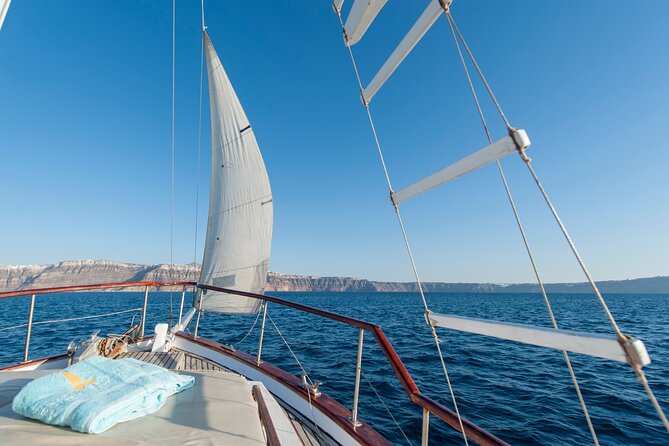 Santorini Caldera Sunset Traditional Cruise with Meal and Drinks - Black Mountain, Indian Rock, and the beach-hopping flow