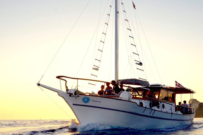 Santorini Caldera Sunset Traditional Cruise with Meal and Drinks - White Beach and Red Beach: boat-only access, photo-friendly colors