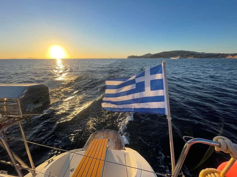 Santorini: Catamaran Cruise with Food and Drinks - White Beach, lighthouse, and the caldera scenery run