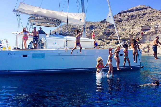 Santorini Catamaran Cruise with Fresh Meal and Open Bar - White Beach from the water: boat access and crystal views
