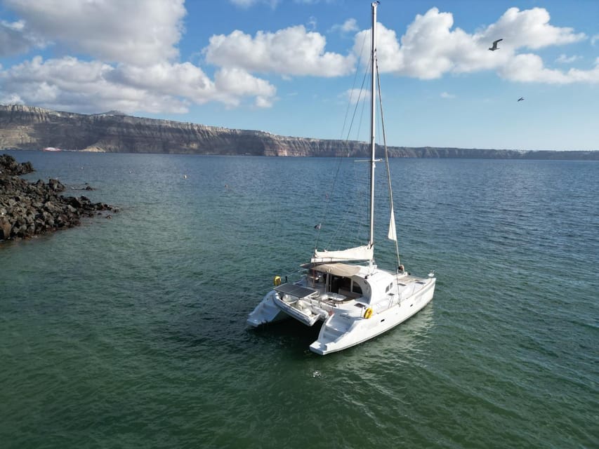 Santorini: Catamaran Cruise with Greek BBQ and Drinks - Hotel pickup or meet at Notos Therme, your choice