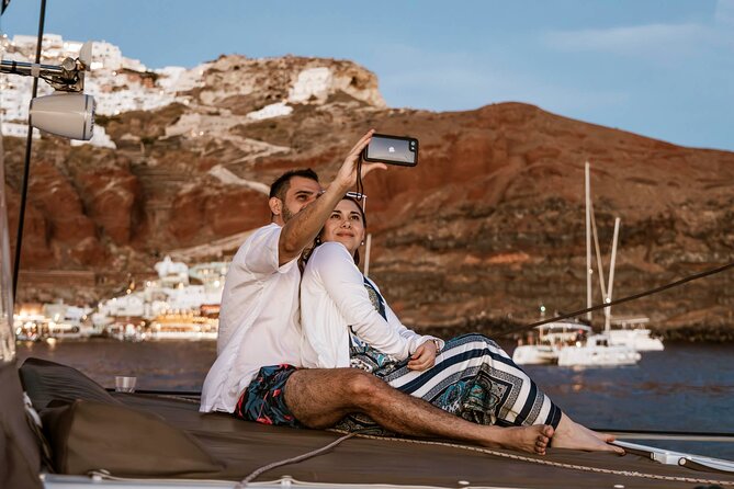 Santorini Catamaran Cruise with Greek Meal, Open-Bar and Sunset - Red Beach Swim Stop: Where the Water Anchors Off Shore