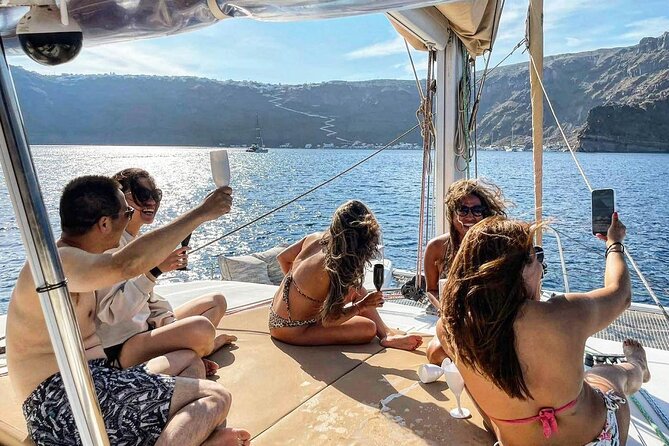 Santorini Catamaran Cruise: with Lunch, BBQ, Open Bar, Transfers - White Beach, Indian Rocks, and the Venetian Lighthouse, from the best angle
