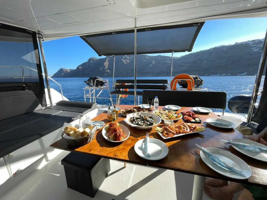 Santorini: Catamaran Cruise with Meal & Open Bar - First swim at Red Beach, plus a quick taste of volcanic color