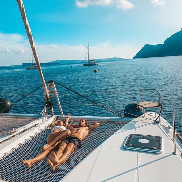 Santorini: Catamaran Cruise with Meal & Open Bar - White Beach sailing break: drinks and a little sightseeing time