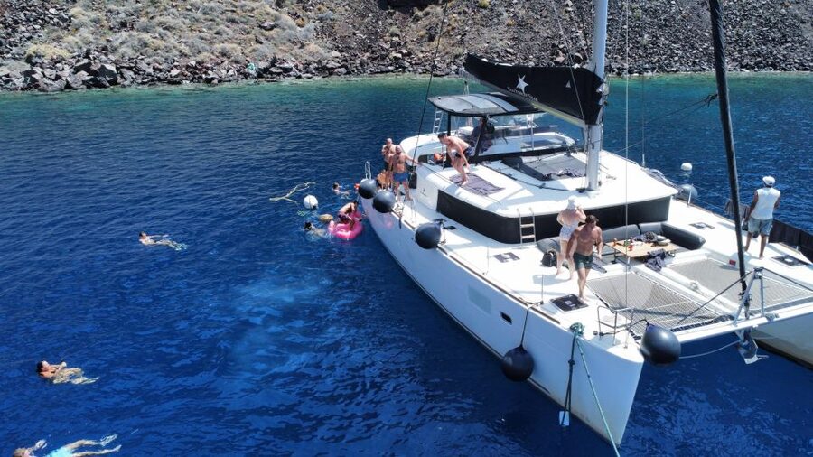 Santorini Catamaran Cruise with Swimming, Meal and Open Bar - Akrotiri Lighthouse pass: the short sailing break that keeps the day moving