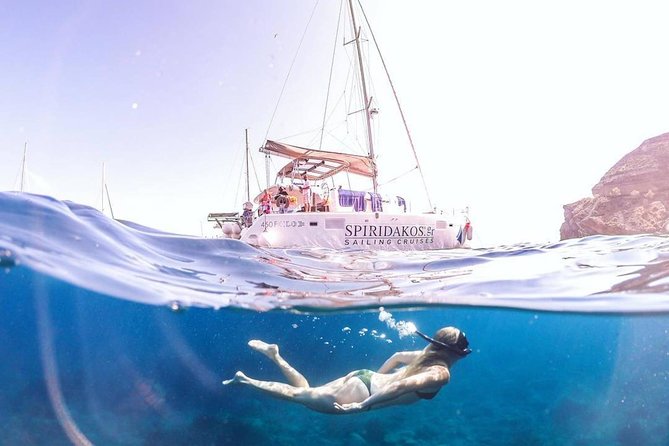 Santorini Classic Catamaran Cruise with BBQ, Drinks and Transfers - Palea Kameni hot springs: the sulfur water stop you feel