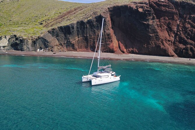 Santorini: Luxury Catamaran Cruise with Fresh Fish BBQ & Drinks - Mesa Pigadia: a black-sand beach for swimming and snorkeling
