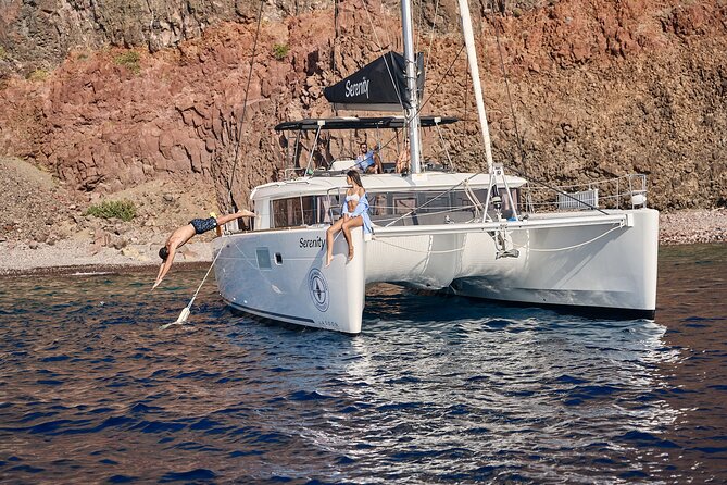 Santorini: Luxury Catamaran Cruise with Fresh Fish BBQ & Drinks - Lighthouse of Santorini and the caldera views that feel different from the cliffs