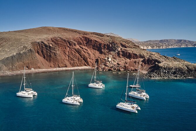 Santorini: Luxury Catamaran Cruise with Fresh Fish BBQ & Drinks - Red Beach, then White Beach color changes: volcanic coast up close