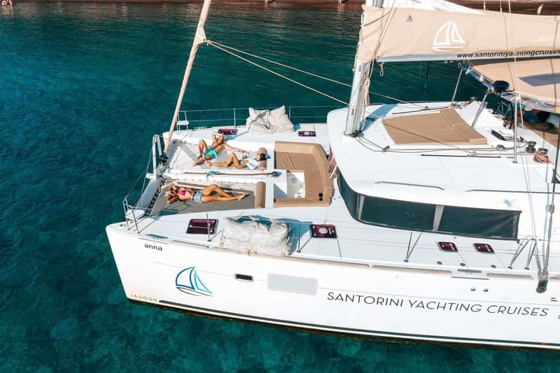 Santorini: Luxury Catamaran Cruise with Lunch, BBQ & Drinks - Caldera sail-by moments: Red Beach, White Beach, and the lighthouse