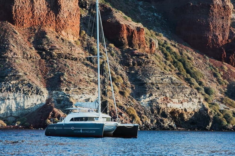 Santorini: Private Catamaran Cruise with BBQ Meal and Drinks - White Beach and Red Beach Swim Stops, plus Boat-Only Coves