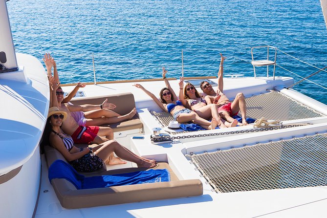 Santorini Private Catamaran Cruise with BBQ, Open Bar & Transfers - BBQ on the volcanic islands: beer, local wine, and time for quiet beaches