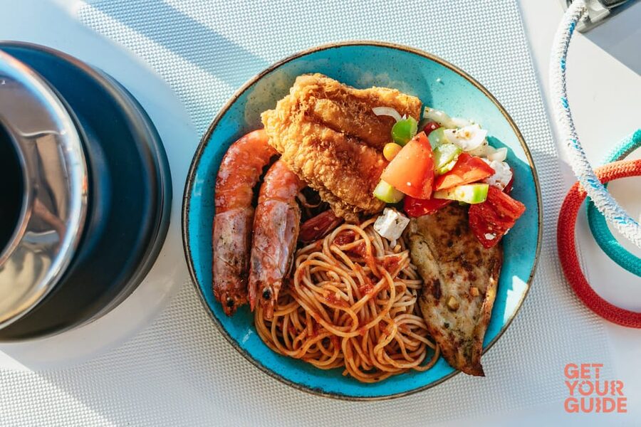 Santorini: Private Catamaran Tour with BBQ Meal and Drinks - Eating BBQ in the caldera light: the lunch that makes the day feel complete