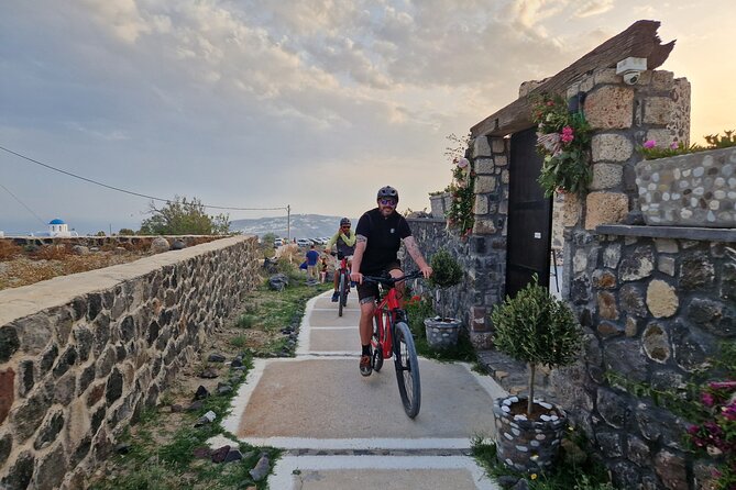 Santorini Small Group Guided E-bike Tour & Local Tomato Museum - Perissa black sand beach: geology you can see, but not a swim session