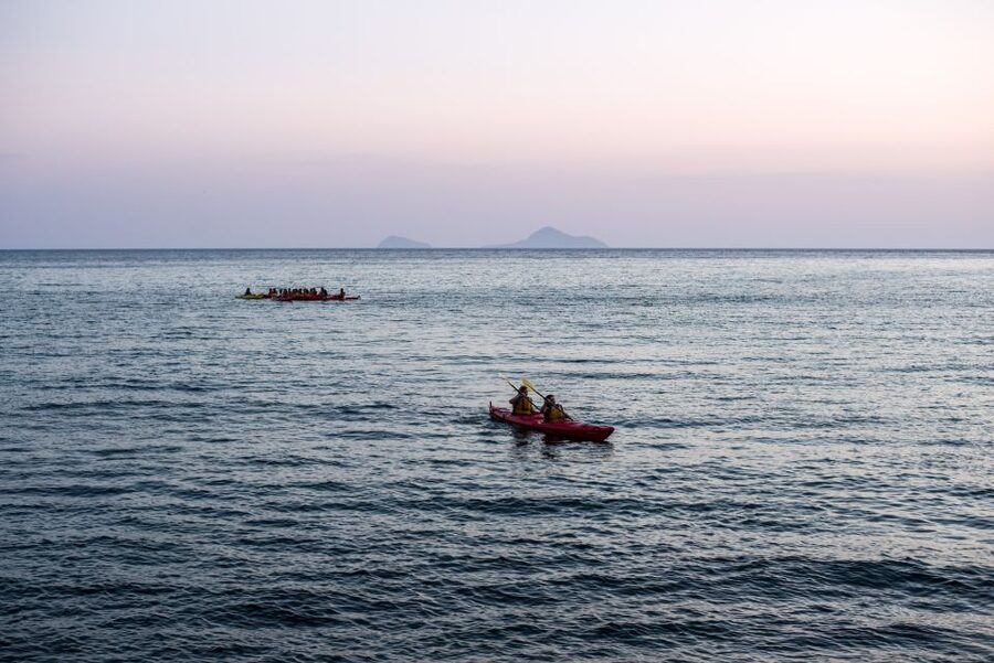 Santorini: Sunset Sea Kayak with Light Dinner - The volcanic colors: white cliffs, red beaches, and black sand from the water