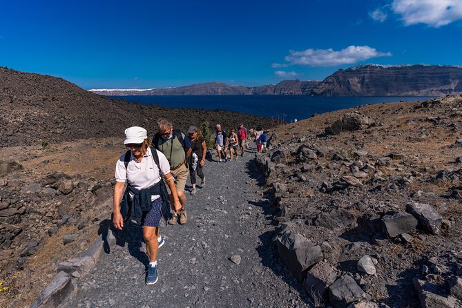 Santorini Tour of Caldera with Glass bottom Boat - The volcano stop: craters, a guided climb, and the extra €5 ticket