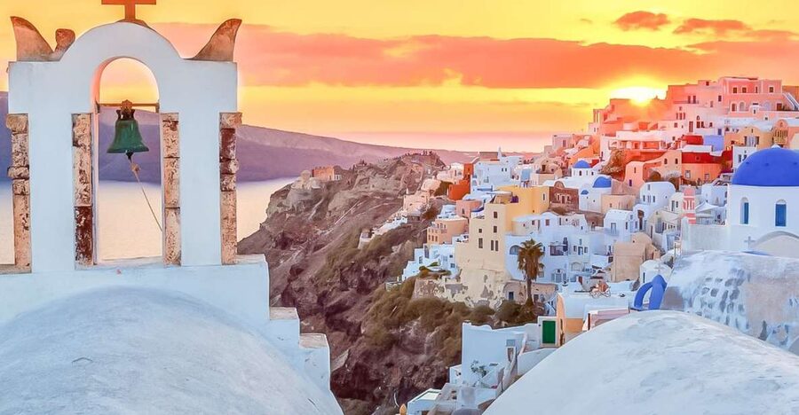Oia at golden hour, blue domes above the caldera