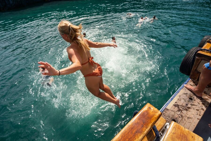 Santorini: Volcanic Islands Cruise with Hot Springs Visit - Cruising Santorini’s caldera from Athinios Port
