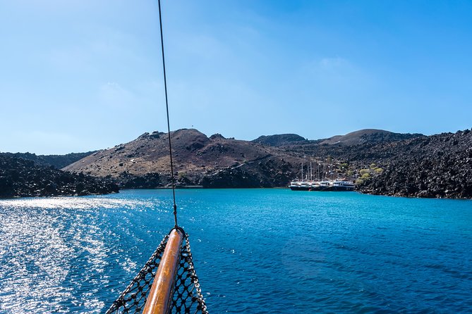 Santorini Volcano and Hot Springs Cruise Tour from Fira Old Port - The boat ride between islands: shade, small comforts, and timing in town