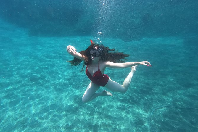 Small-Group Santorini Sea Caves Kayak Trip with Snorkeling & Picnic - White Beach cliff jumping and snorkeling stops that break up the work